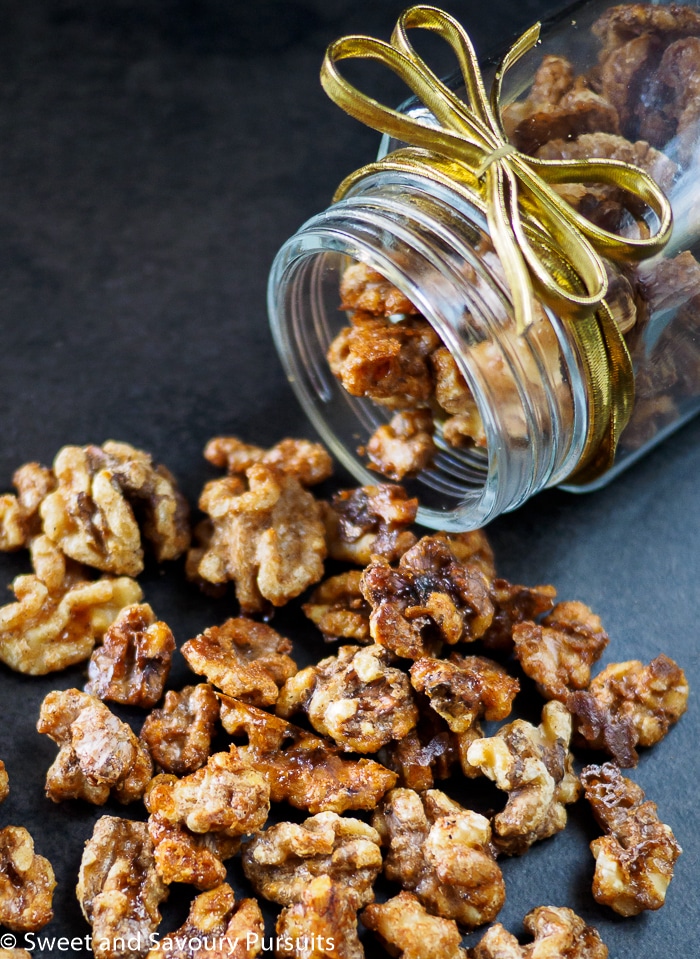 Maple spiced walnuts coming out of jar.