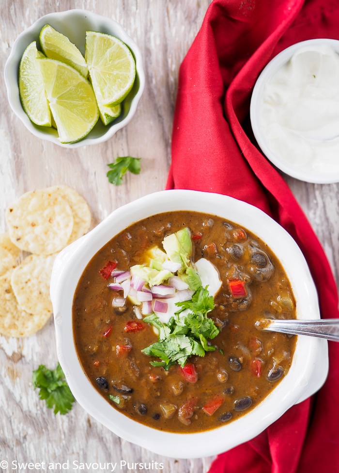 Bowl of black bean soup served with corn chips.