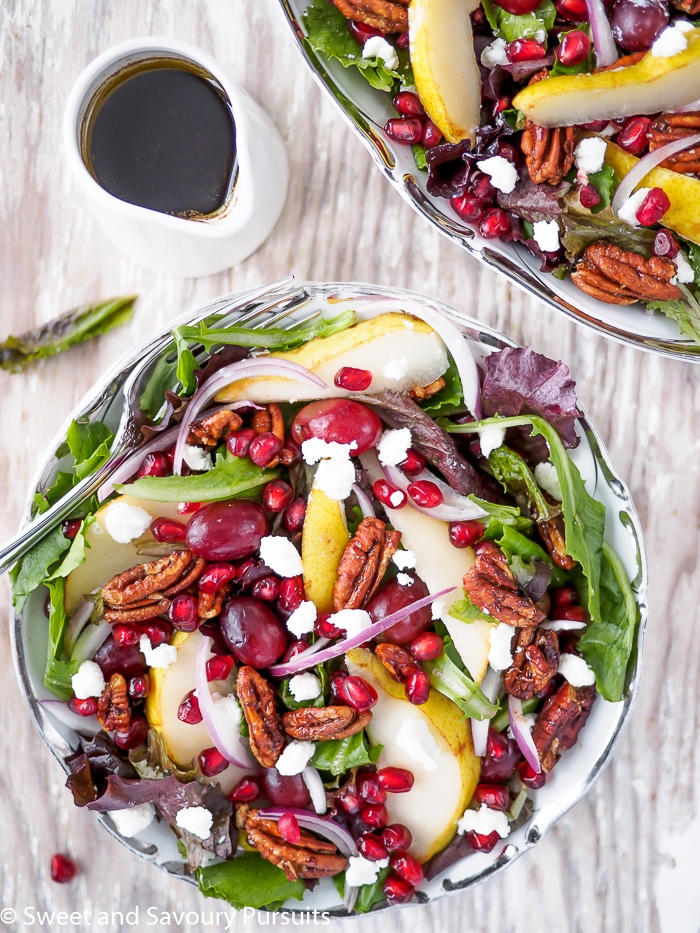 Pomegranate, Pear, Pecan Salad served with a balsamic vinaigrette.