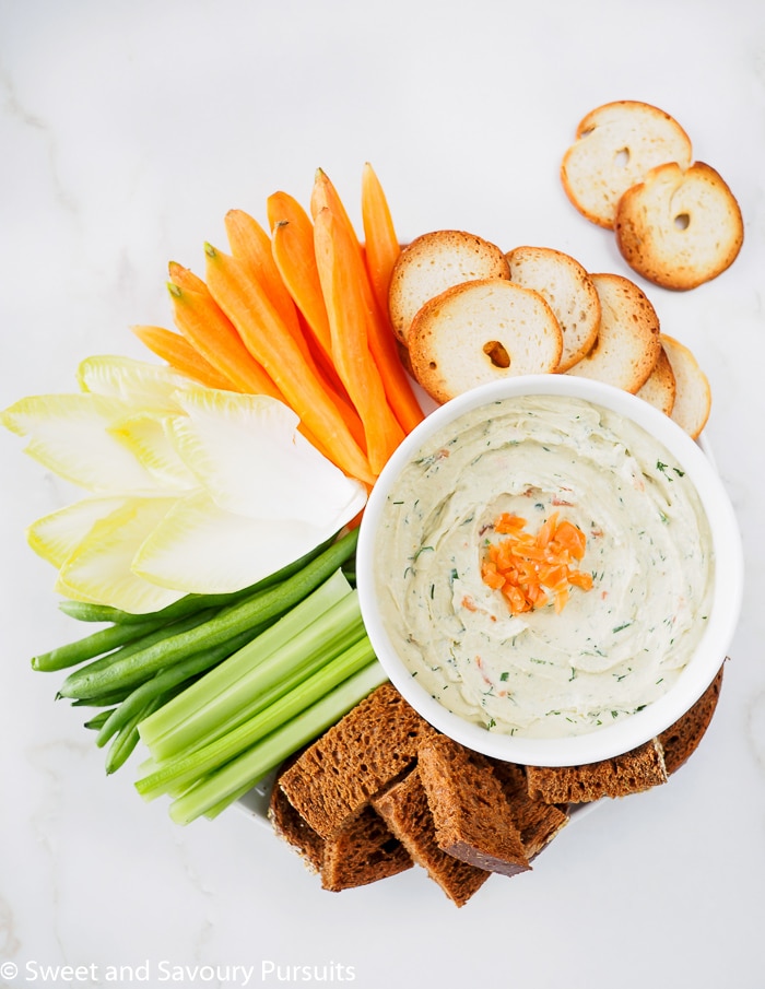 A Smoked Salmon Cream Cheese Dip served with veggies, bread and bagel crackers.