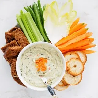 Smoked Salmon Cream Cheese Dip served with vegetables, pumpernickel bread, and bagel crisps