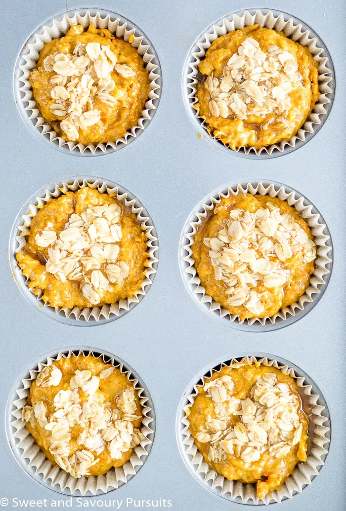 Unbaked Carrot Muffins in baking tin.