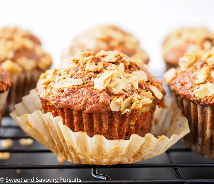 Baked carrot muffins on cooling rack.