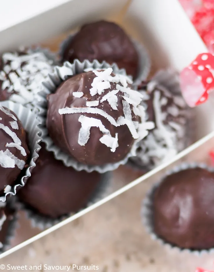 Top view of a box of chocolate coconut truffles.