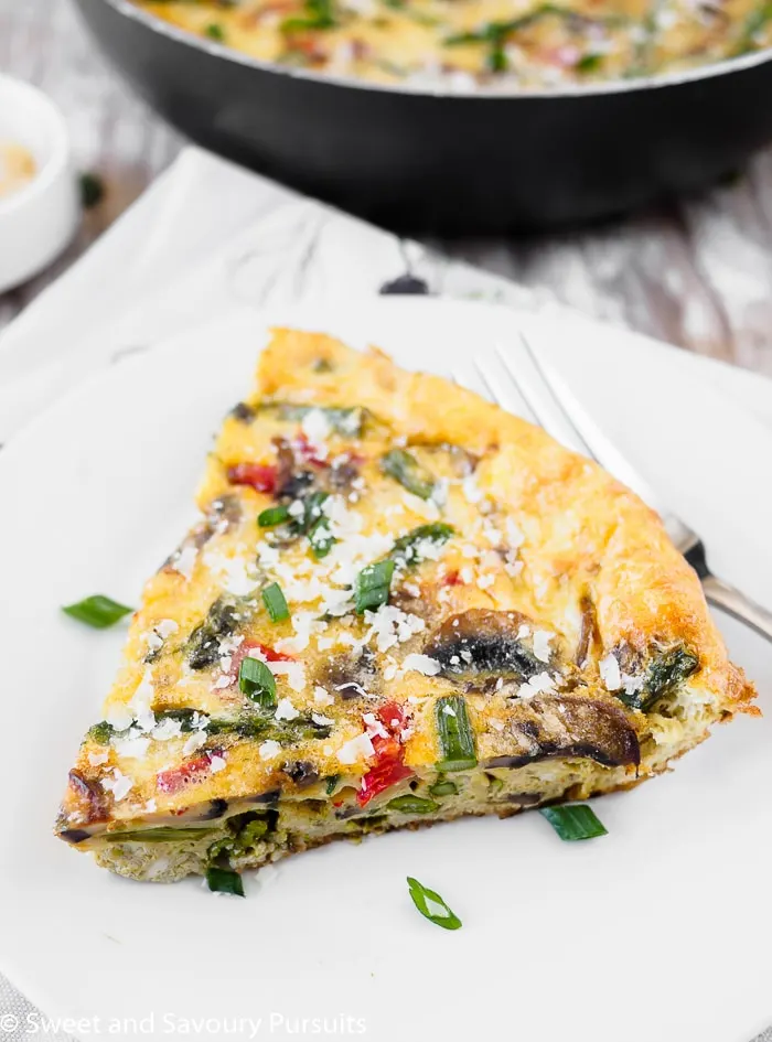 A serving of vegetable frittata on white dish