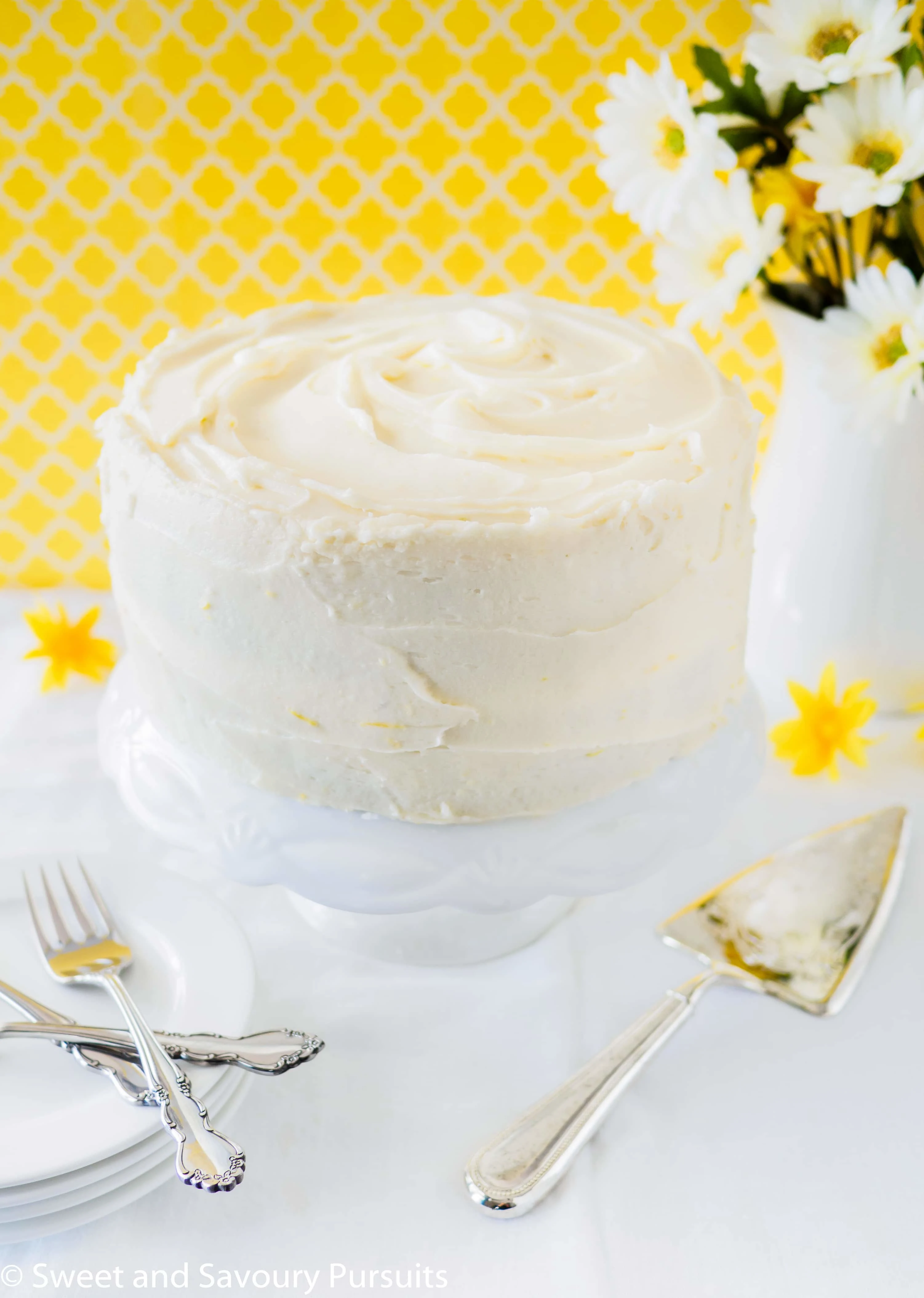 A layered lemon poppy seed cake frosted with a lemon infused cream cheese frosting.