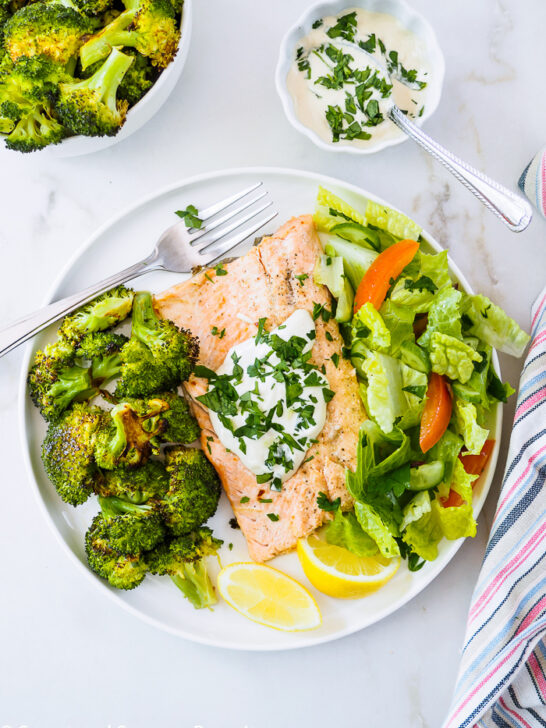 A serving of Baked Rainbow Trout Fillets with Roasted Broccoli on dish.