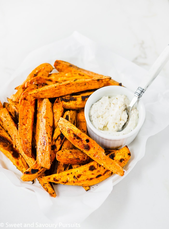 Baked sweet potato wedges served with baked feta cheese on the side.