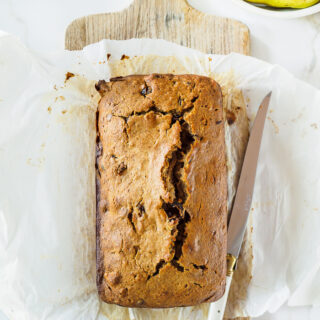 Top view of Pear, Date and Walnut Loaf on wooden cutting board.