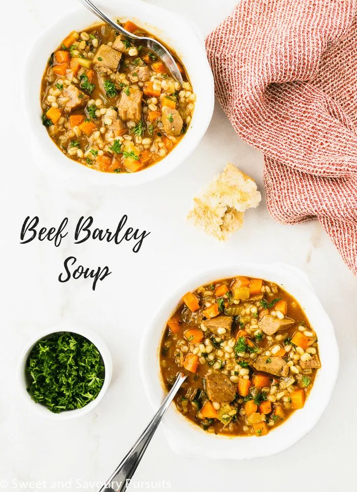 Beef Barley Soup served in two white bowls.