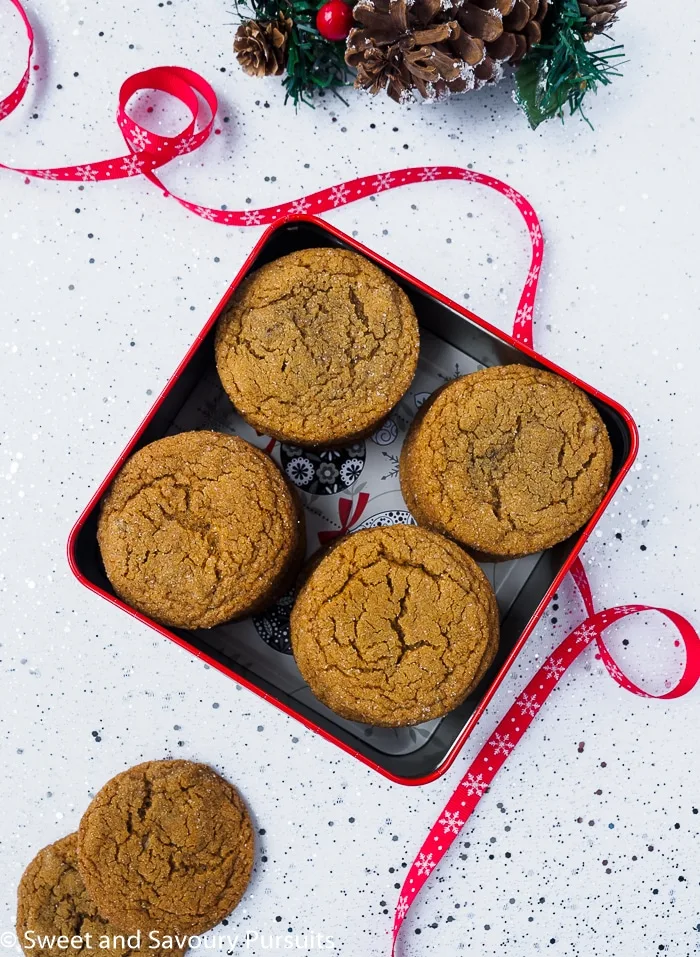 Complete your cookie tray with these tender, sweet and flavourful Chewy Ginger Cookies made with molasses and ground and candied ginger. Chewy Ginger Cookies in cookie tin.