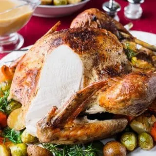 Roast turkey with slice cut off to expose cooked breast.