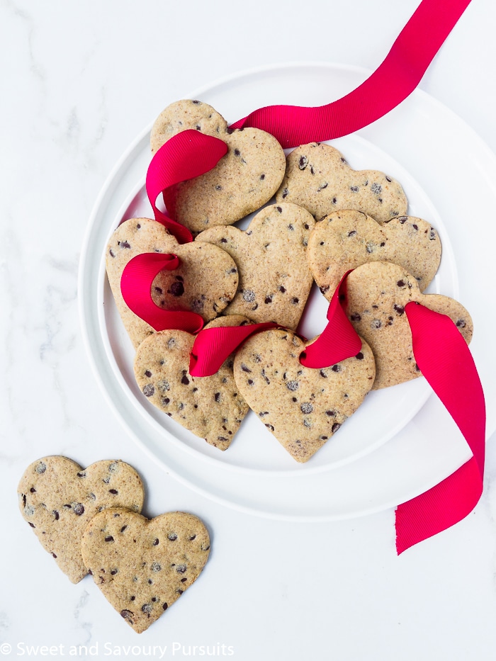 Plate of heart shaped chocolate chip sugar cookies.