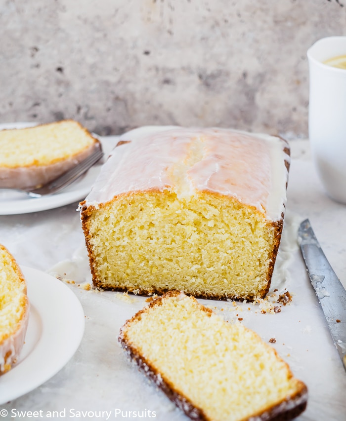 Lemon loaf with cut slice on board. 