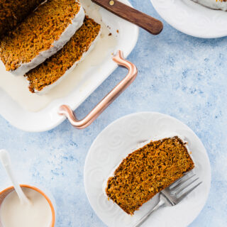 Healthy Carrot Bread served on platter with a slice on a white dish.