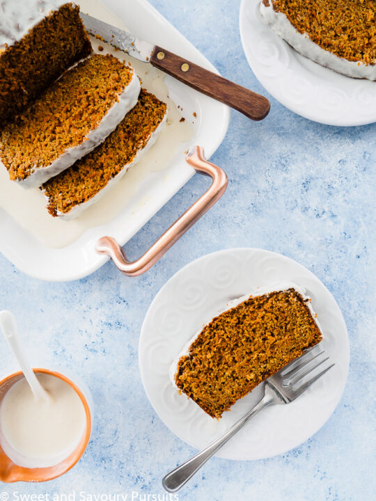 Healthy Carrot Bread served on platter with a slice on a white dish.