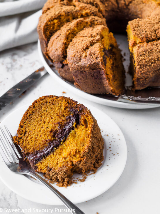 A plated slice of pumpkin cake with a chocolate swirl.