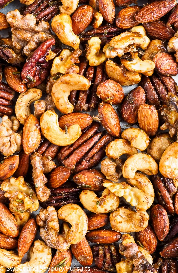 Roasted mixed spiced nuts on baking tray.