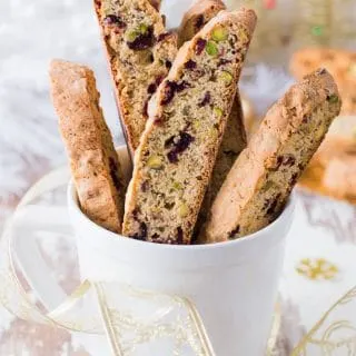 Pistachio and Cranberry Biscotti in white mug.