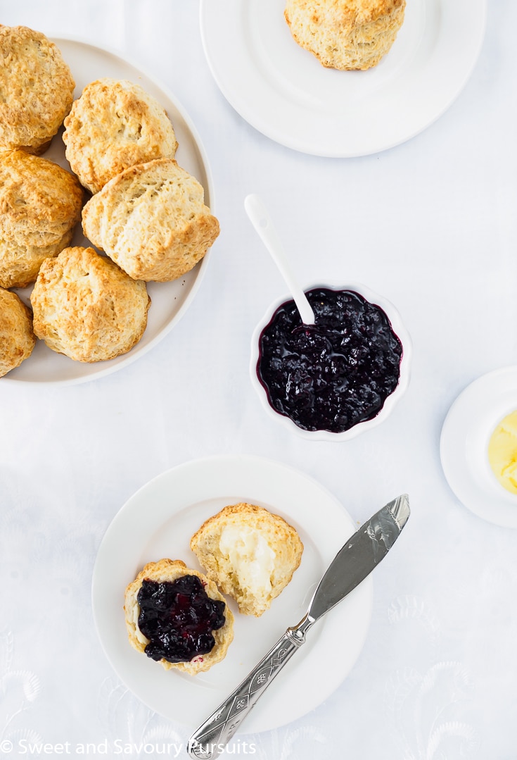 Dish of scones served with butter and a homemade jam.