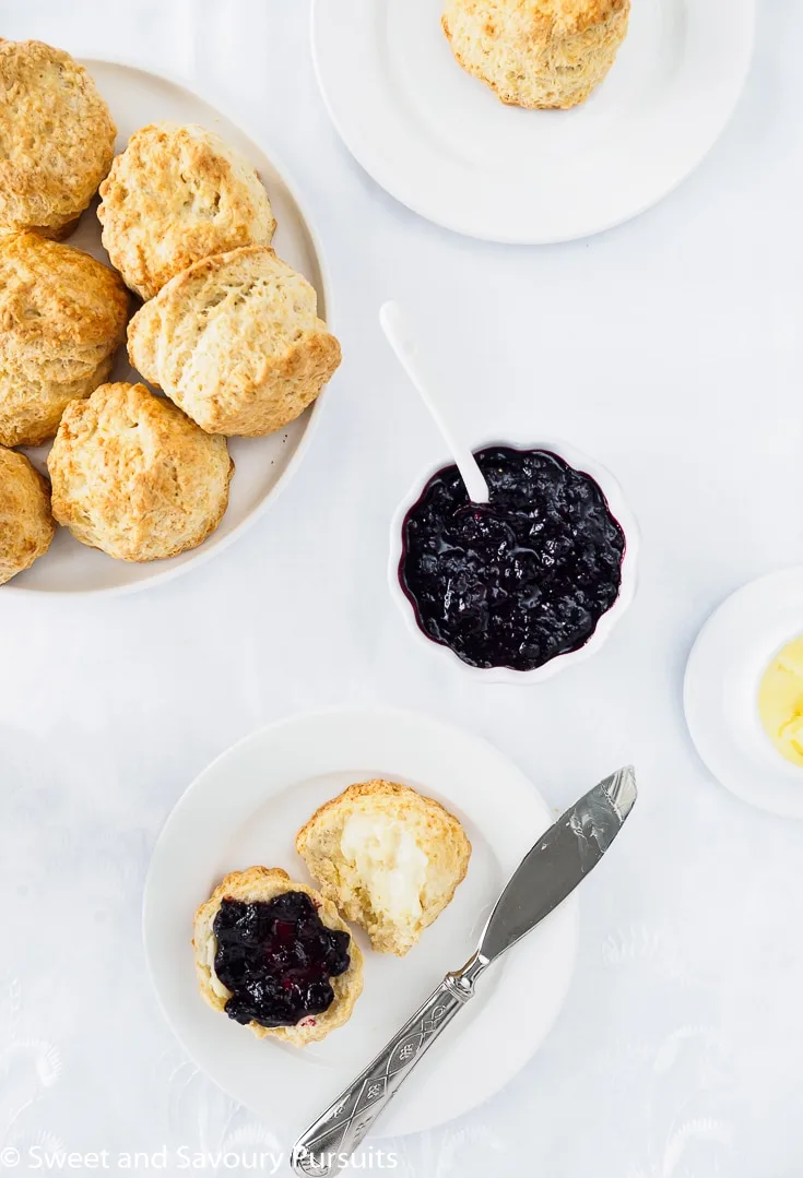 Dish of scones served with butter and a homemade jam.