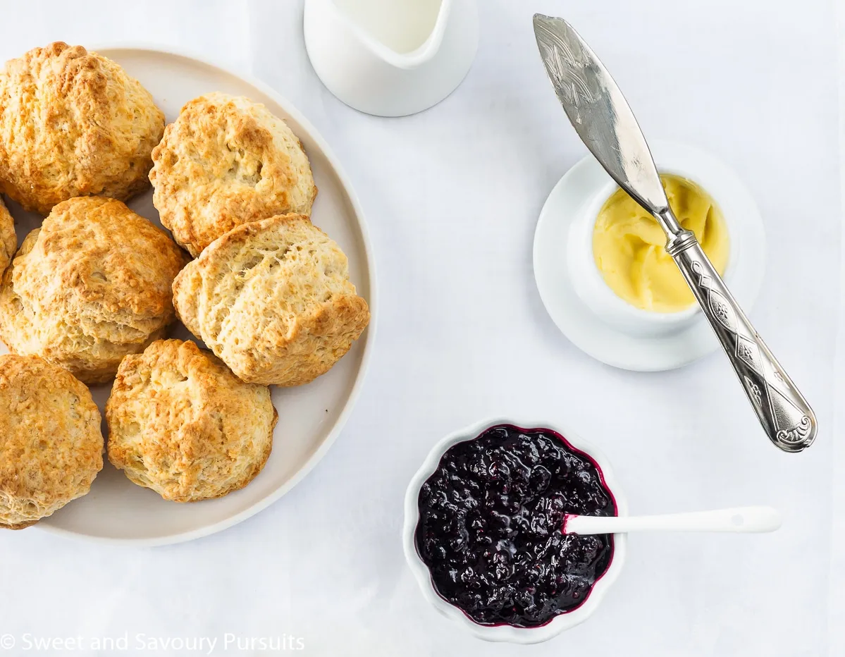 A dish of Irish scones served with butter and jam.