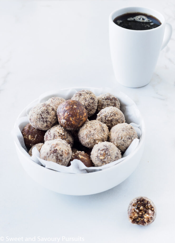 Bowl of already made No-Bake Maple Espresso Bites served with a cup of coffee.