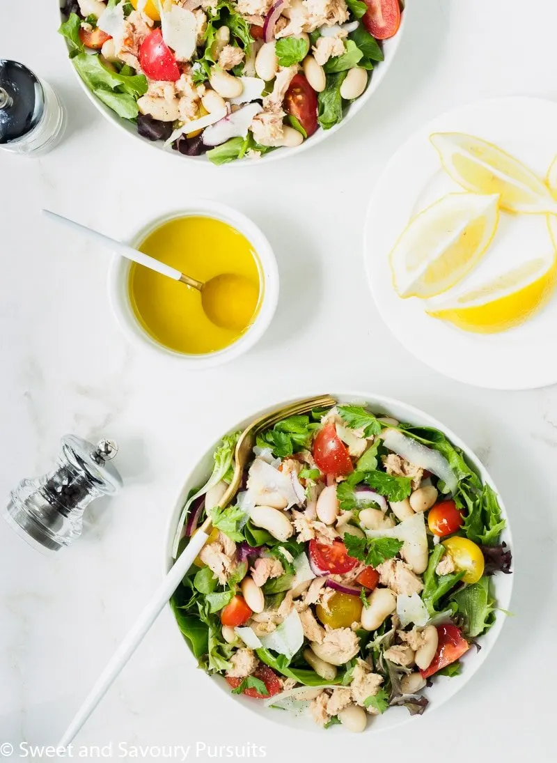 Bowls of Bean and Tuna Salad served with a lemon and olive oil dressing on the side.