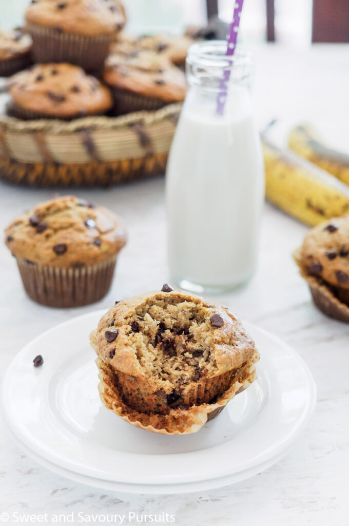 Partially eaten Banana Oatmeal Chocolate Chip Muffin with more muffins in the background.
