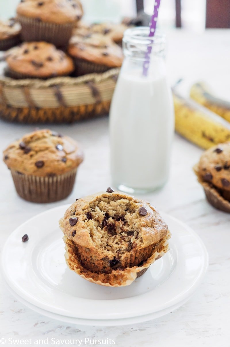 Partially eaten Banana Oatmeal Chocolate Chip Muffin with more muffins in the background.