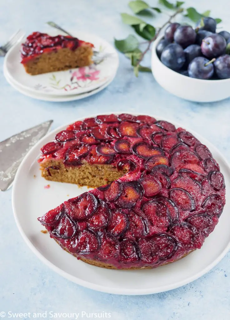 Plum cake with slice removed.