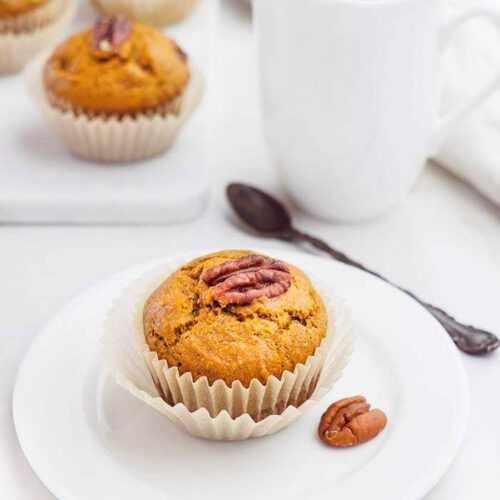 A Sweet Potato Muffin served on a small white dish.