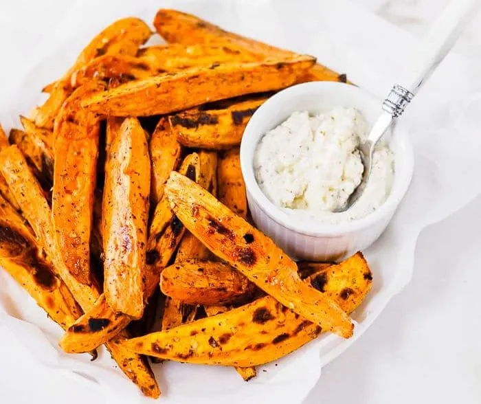 Plate of Baked Sweet Potatoes with a side of softened feta cheese.