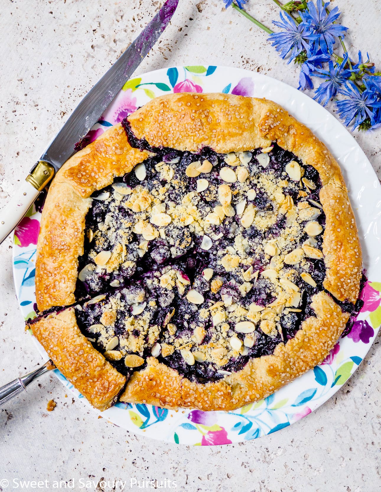 Blueberry galette topped with sliced almonds.