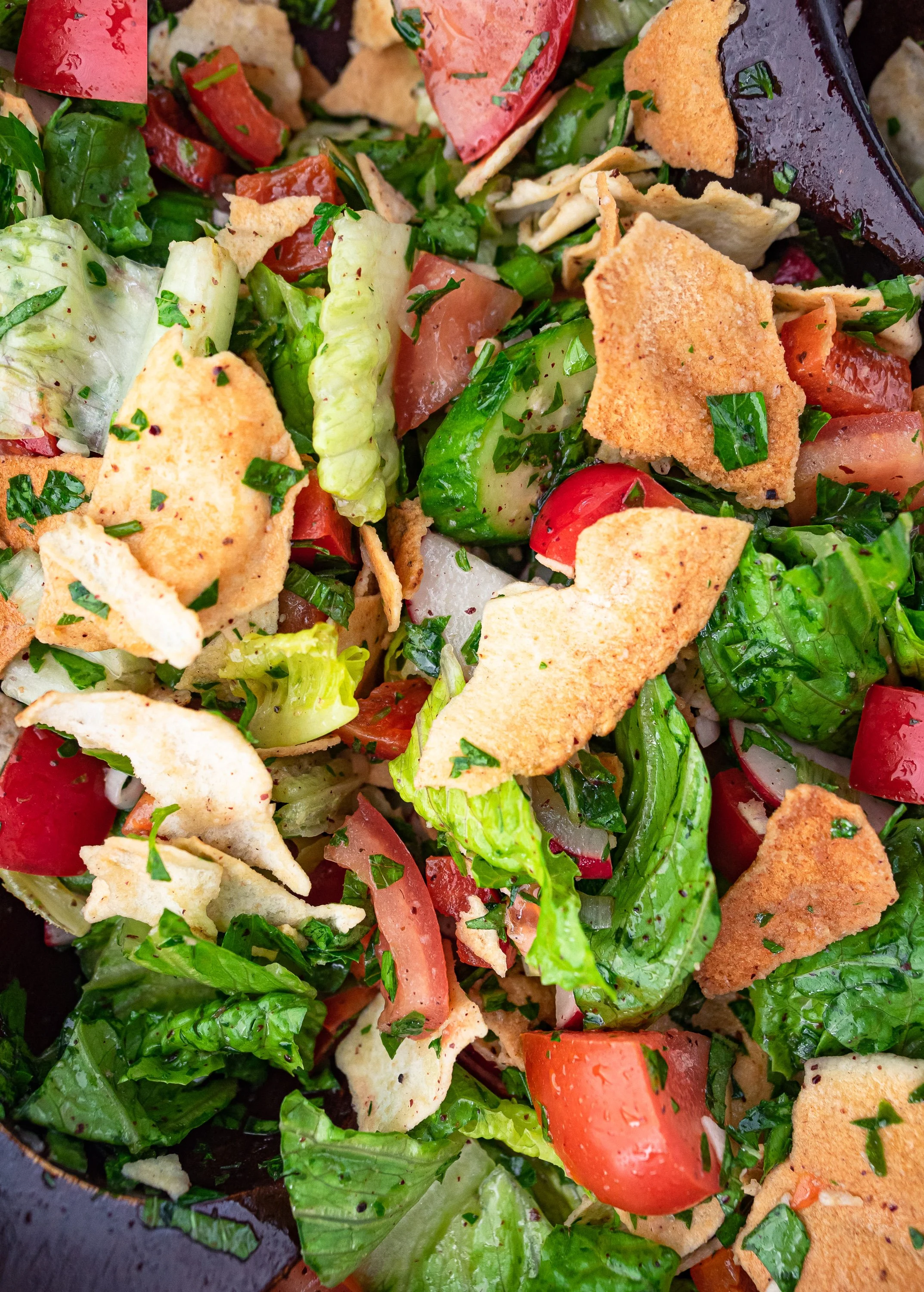 Close-up of a dressed and tossed fattoush salad.