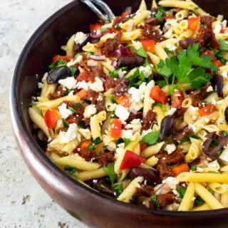 Mediterranean Pasta Salad in a large wooden bowl.