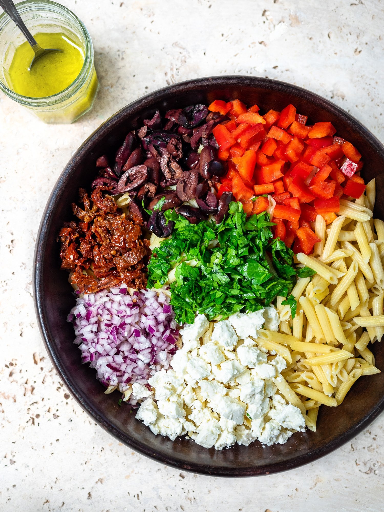 Top view of large bowl of pasta salad.