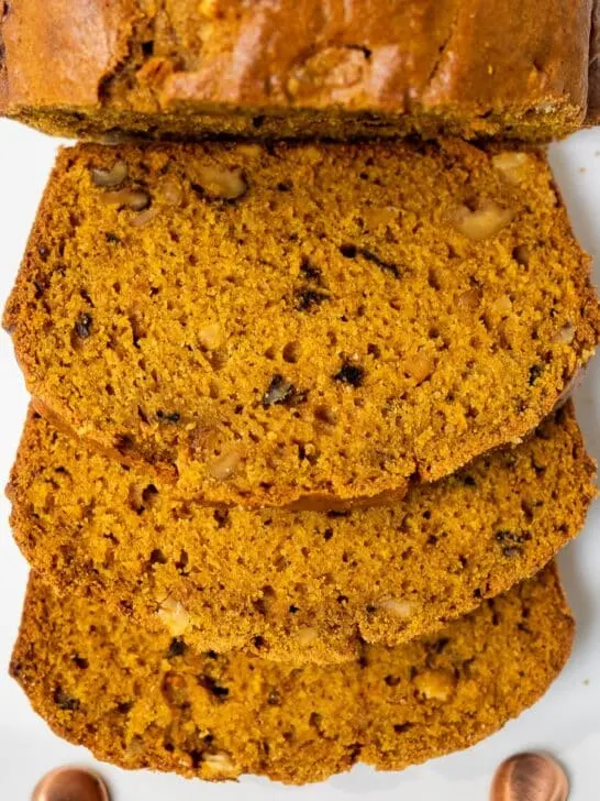 Sliced pumpkin bread on platter.