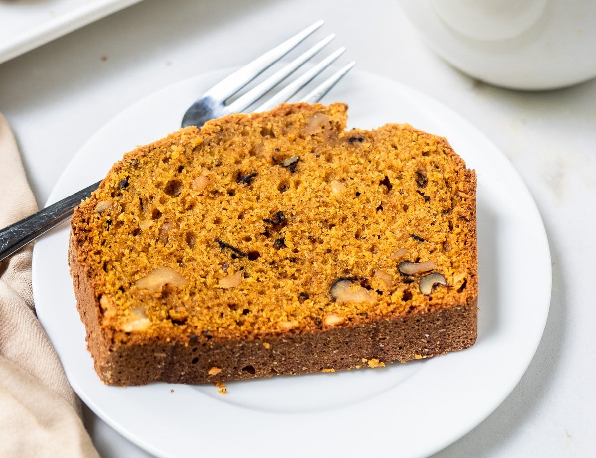 Slice of pumpkin bread on small dish.