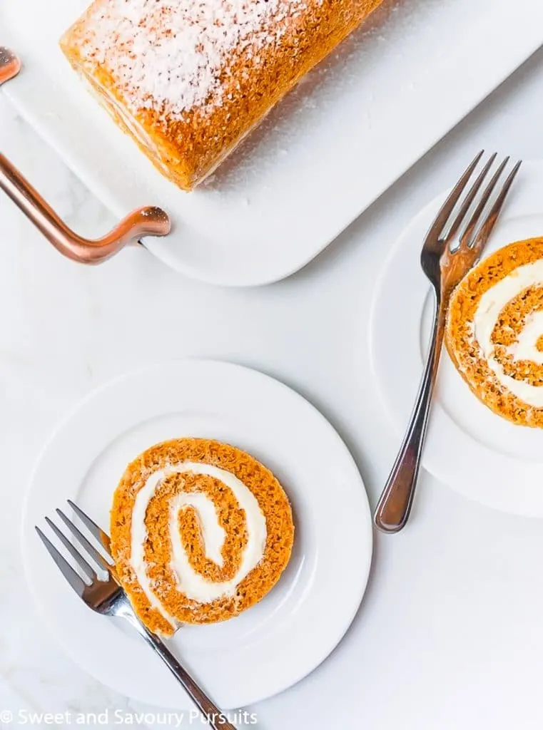 Plated slices of a pumpkin roll cake.