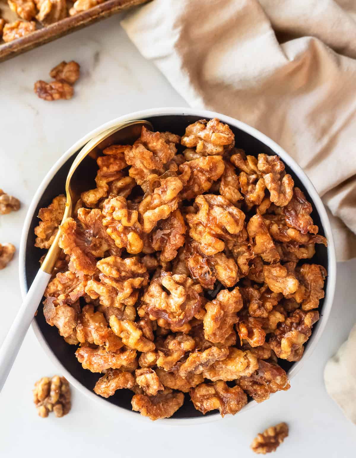 Bowl of maple and spice roasted walnuts.