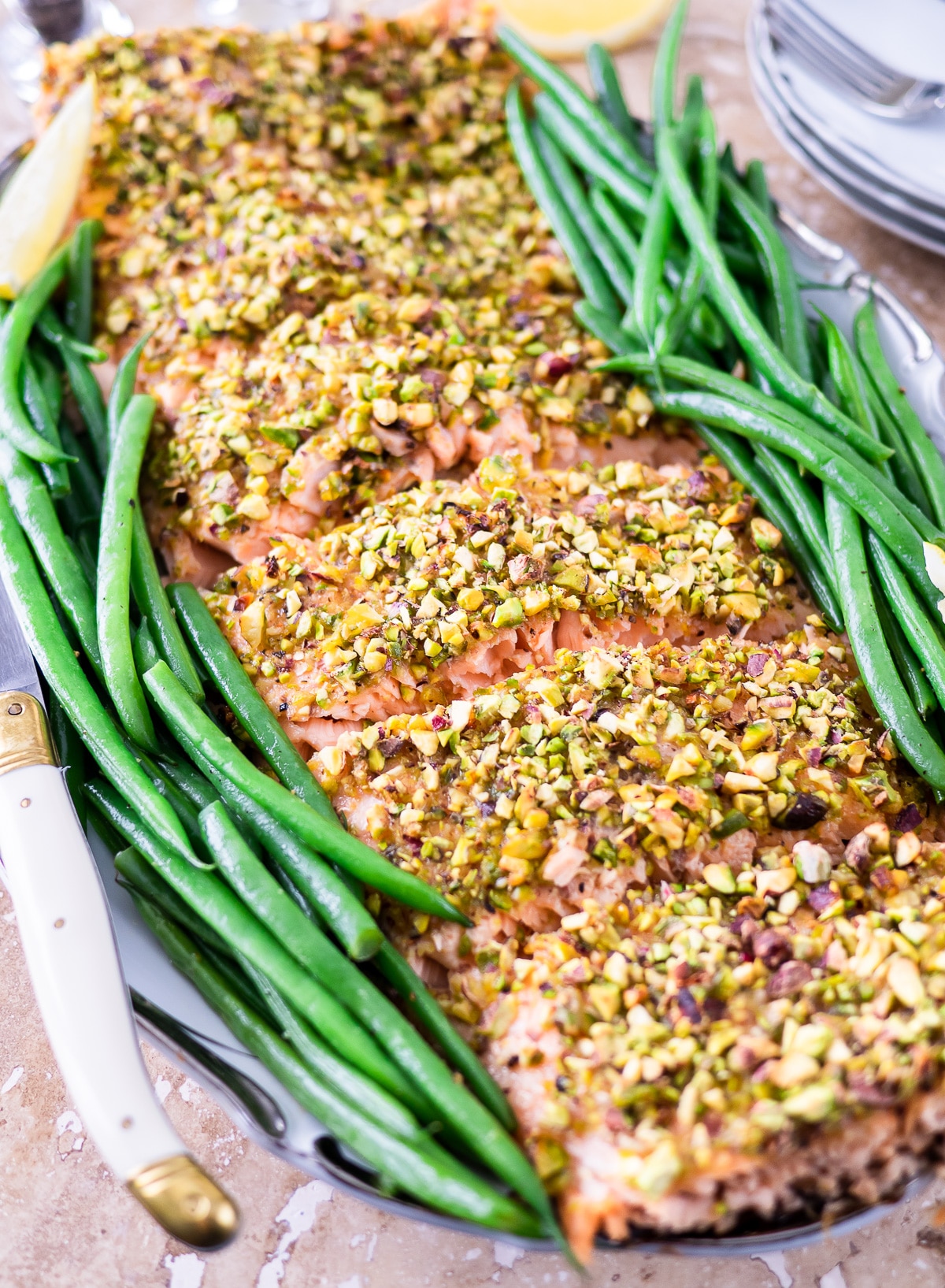 Filet of pistachio crusted salmon on platter.