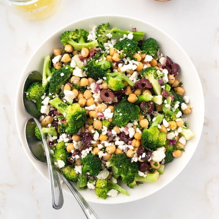 Bowl of chickpea and broccoli salad topped with feta cheese.