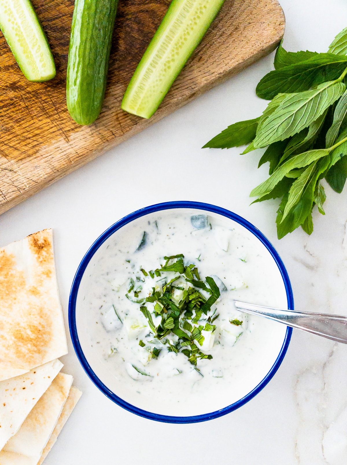 Bowl of cucumber, yogurt and mint salad.