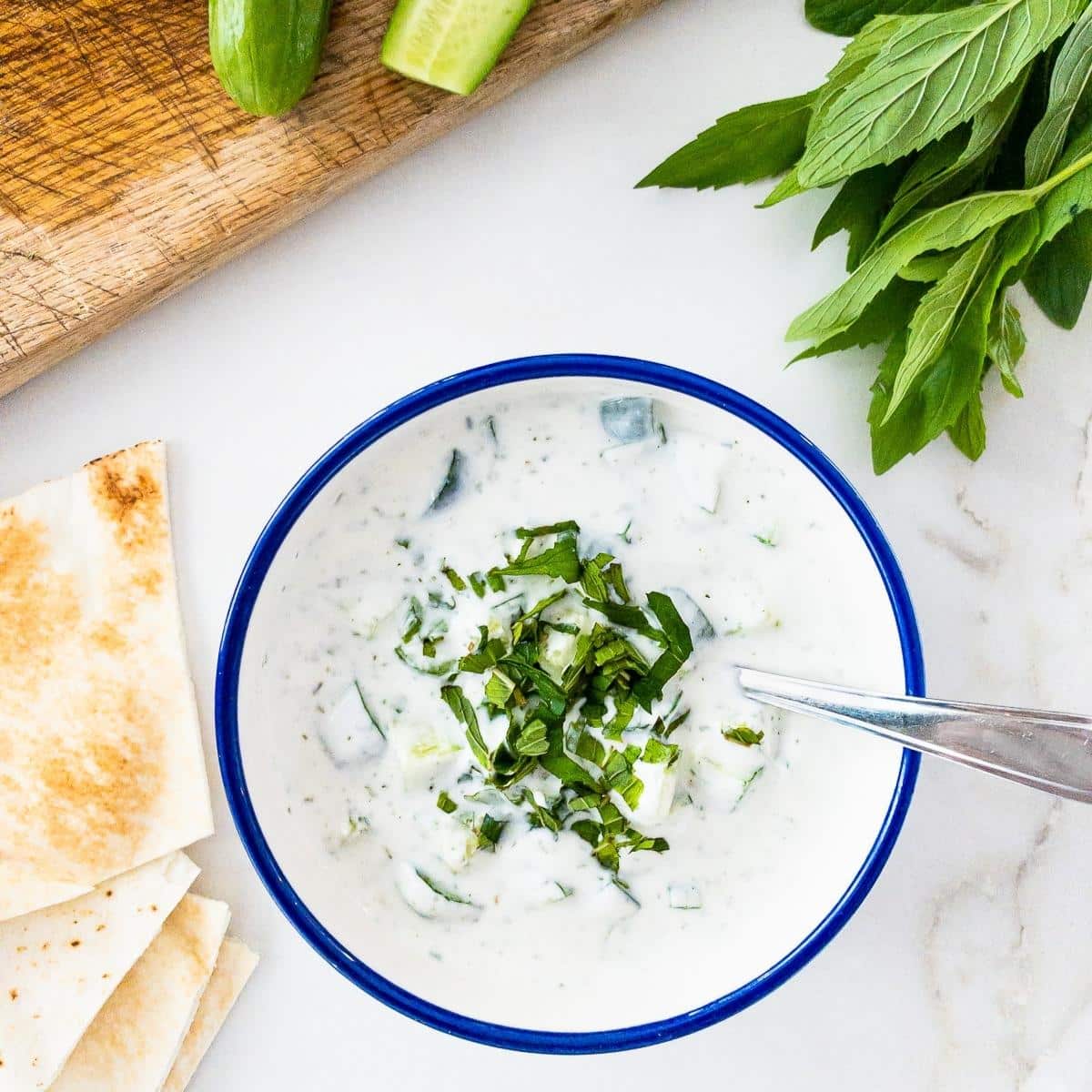 Bowl of cucumber, yogurt and mint salad.