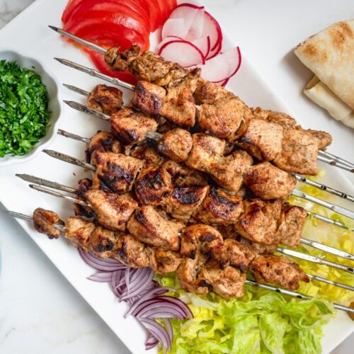 Platter of chicken shawarma skewers.