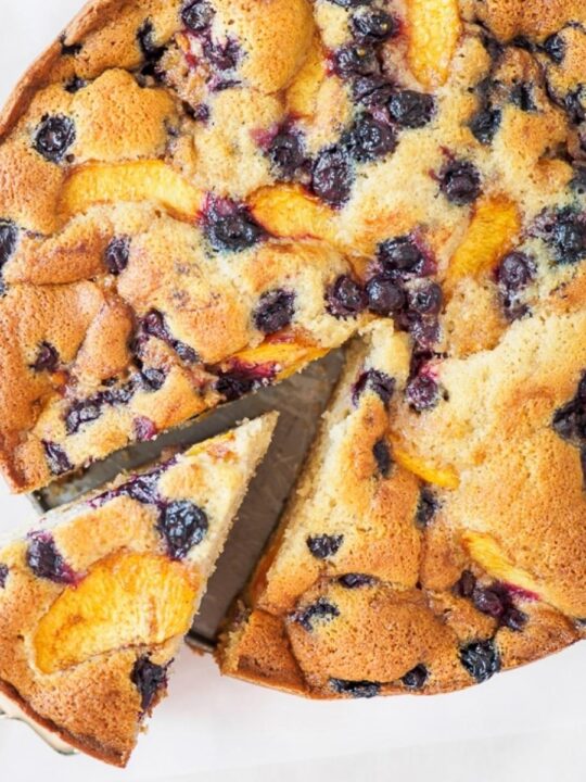 Top view of peach and blueberry cake.