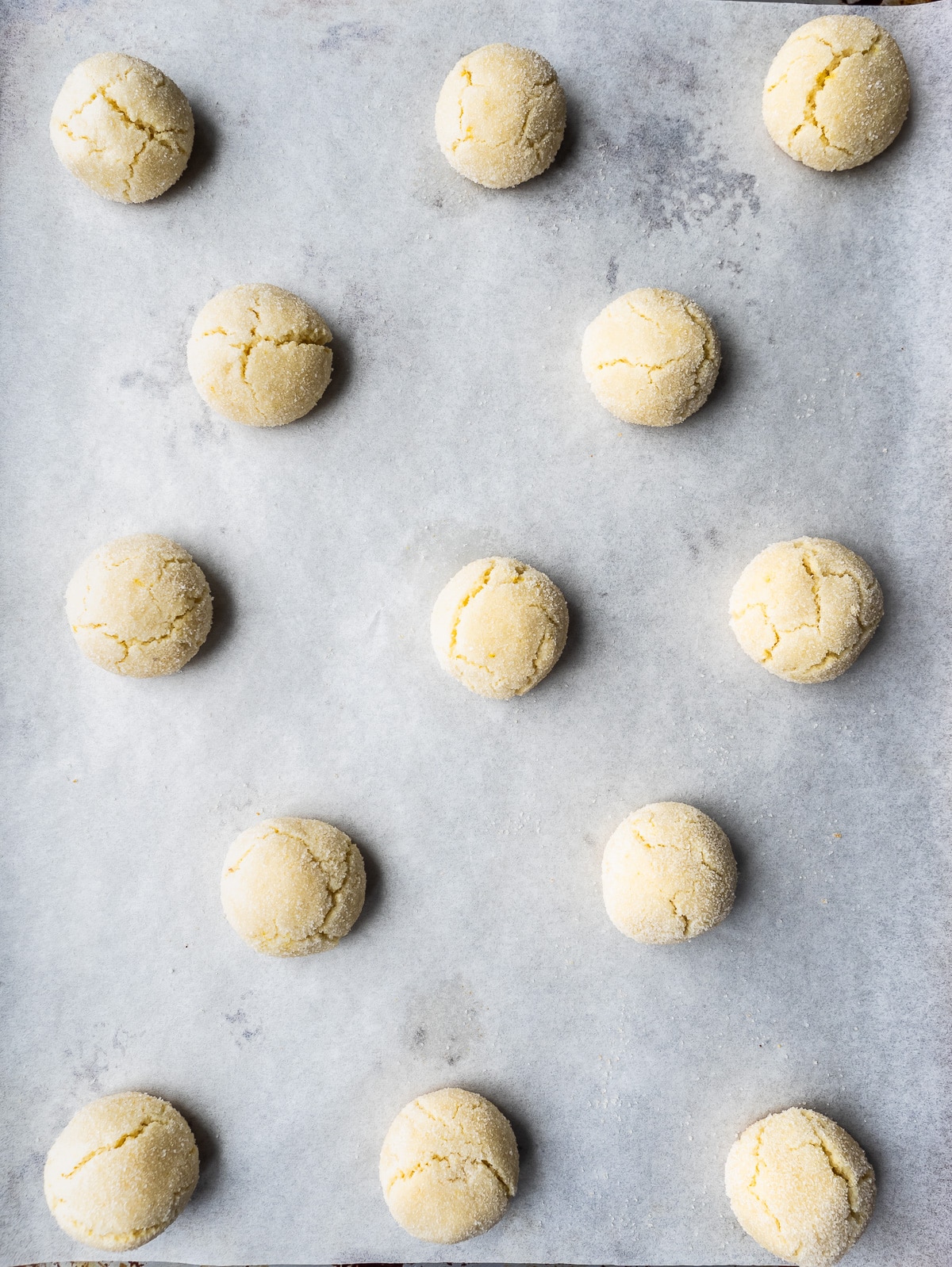 Baked amaretti cookies on sheet pan.