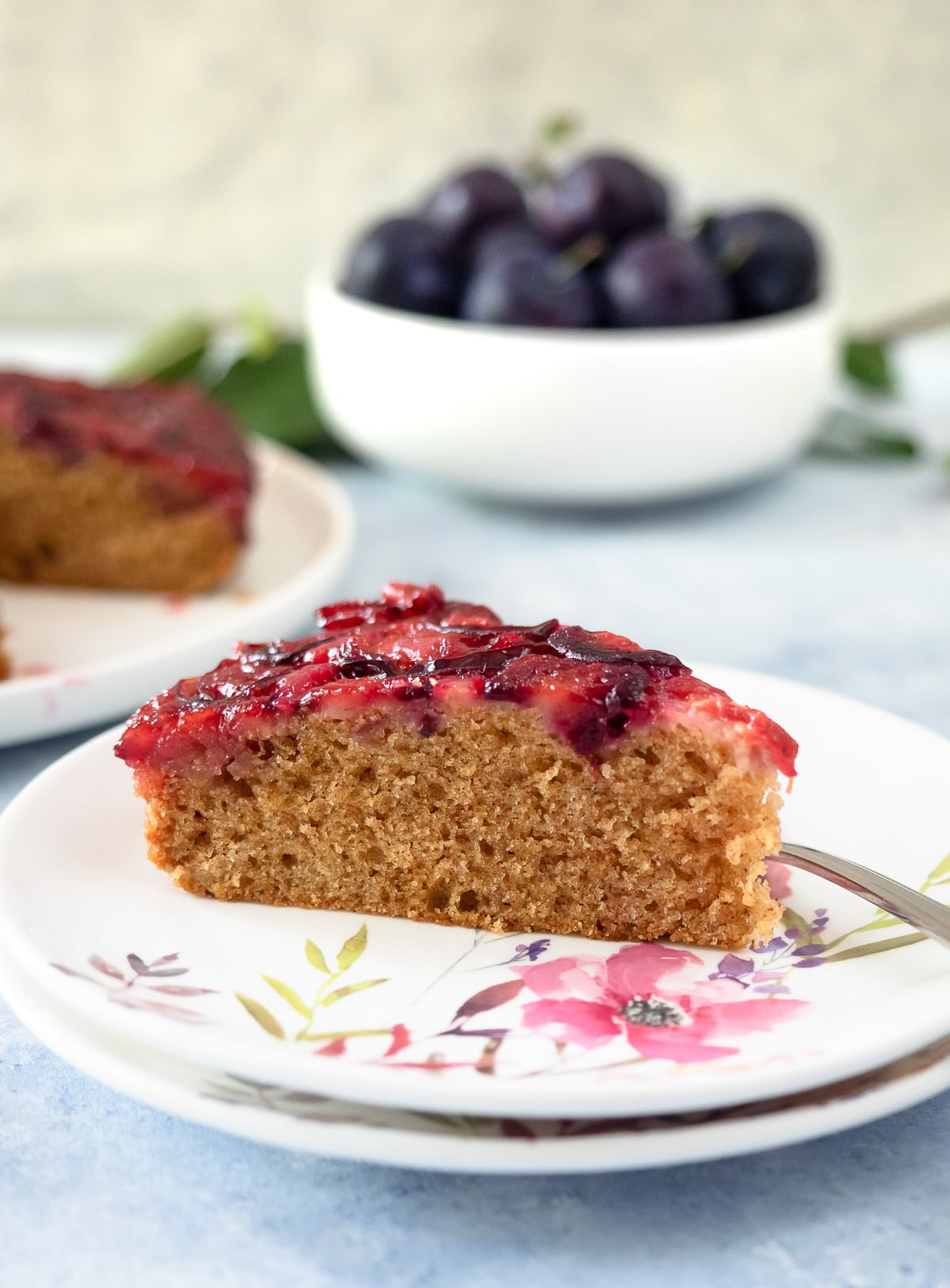 Slice of plum cake on dish.