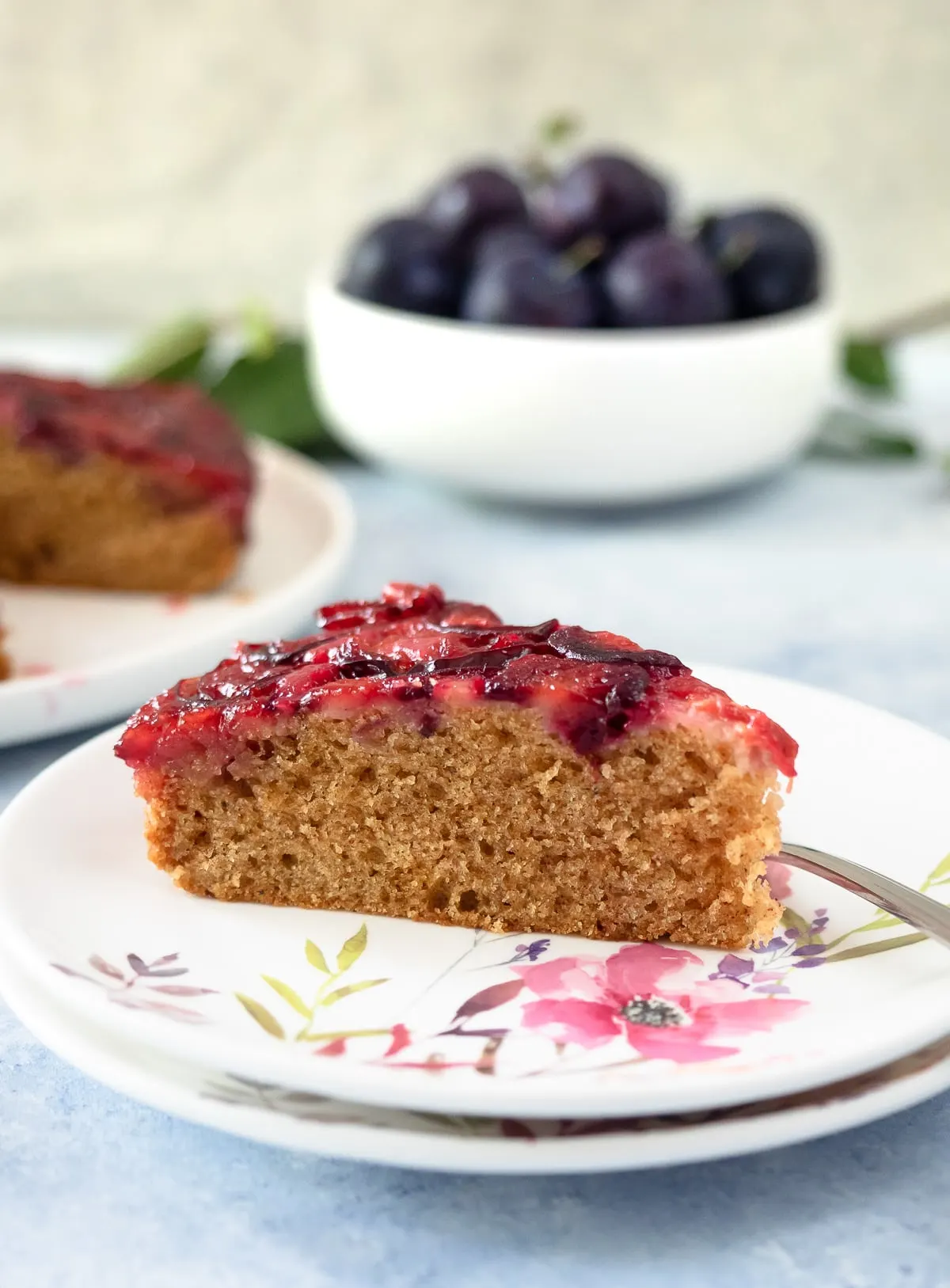 Slice of plum cake on dish.